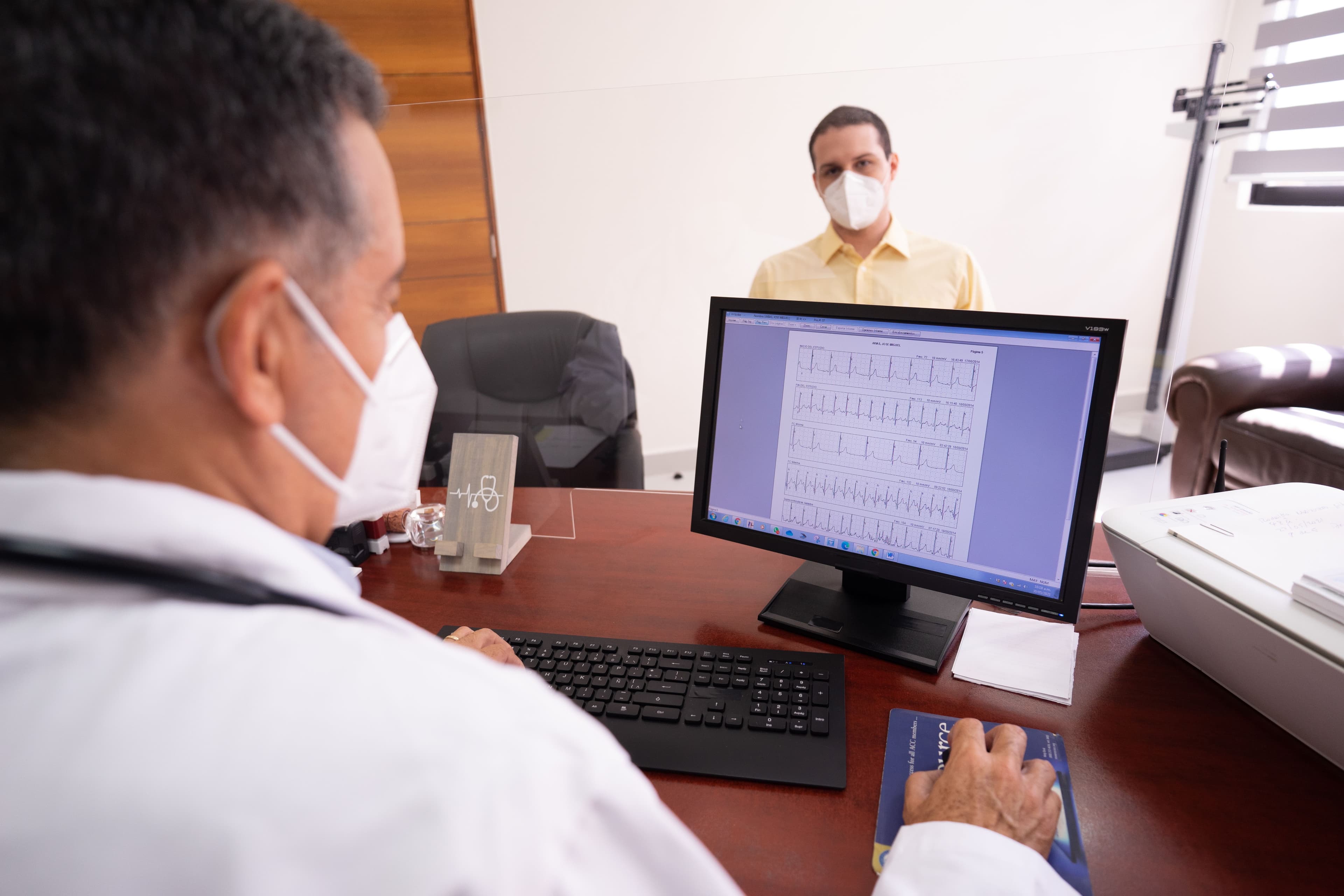 Clinician reviewing patient monitoring data on screen