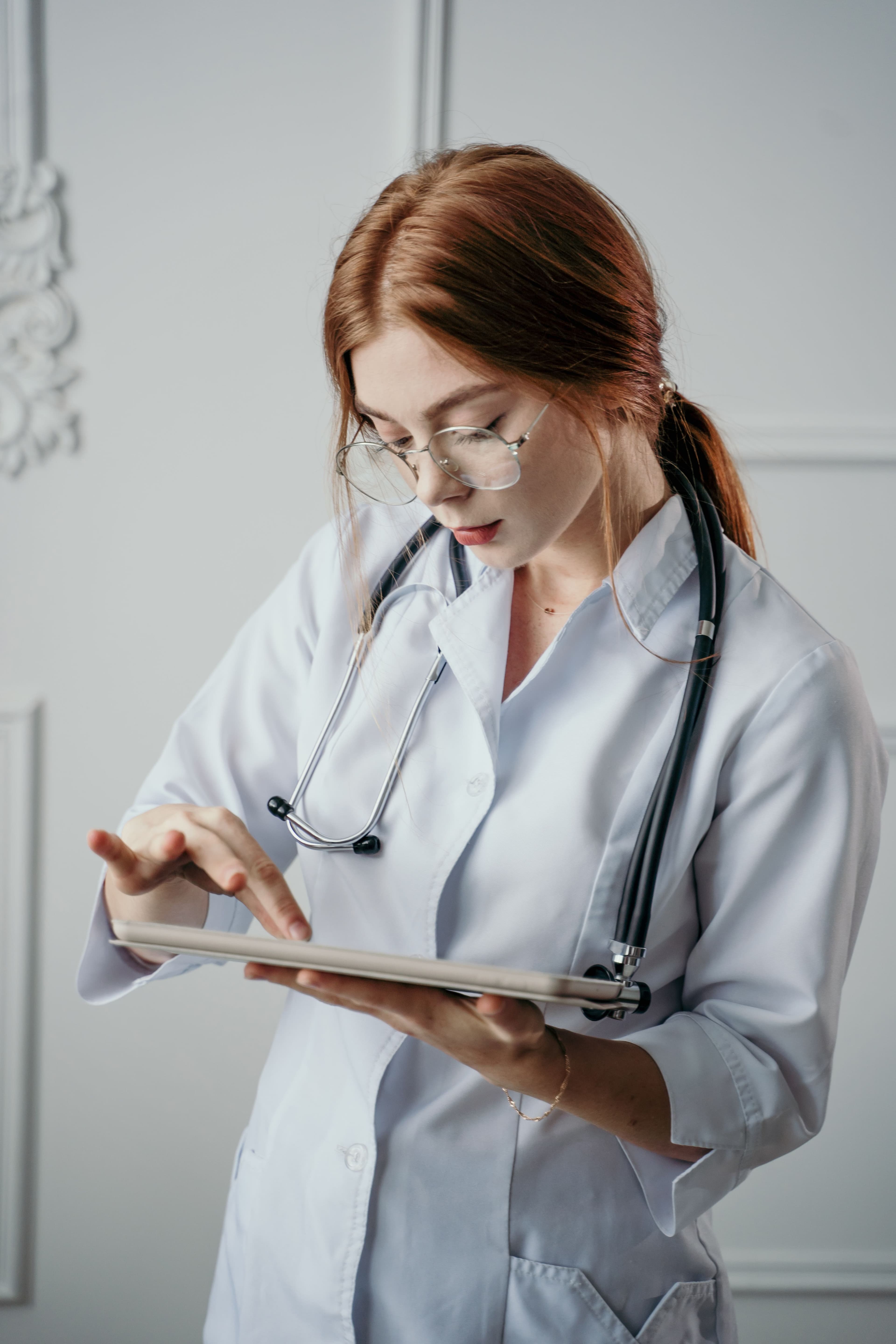 Clinician reviewing patient information on a tablet